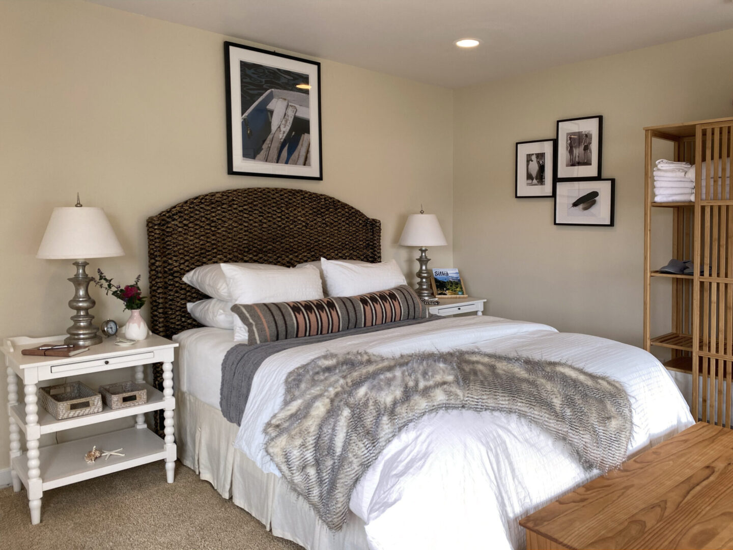 A bedroom with a bed, nightstand and two lamps.