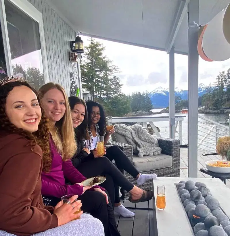 A group of people sitting on top of a deck.